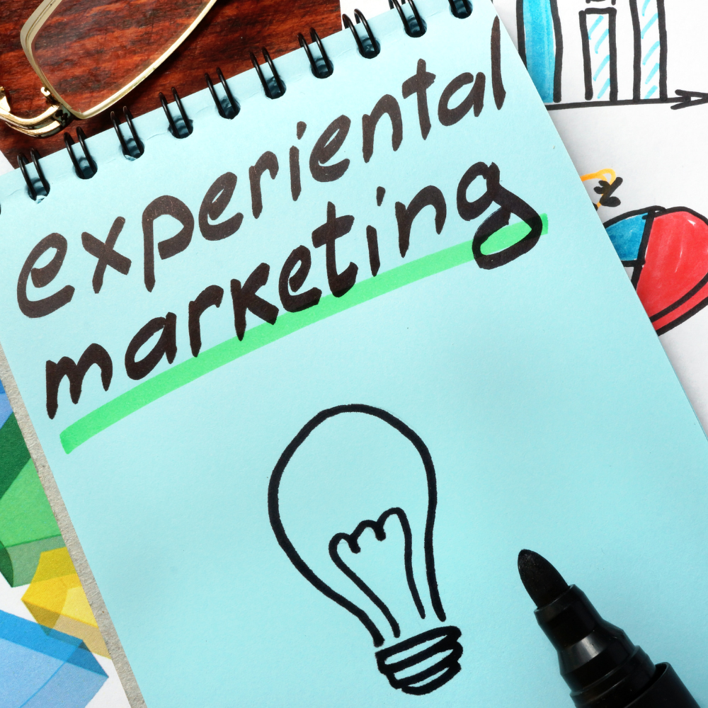 A notepad featuring the words "experiential marketing" and a drawing of a lightbulb.