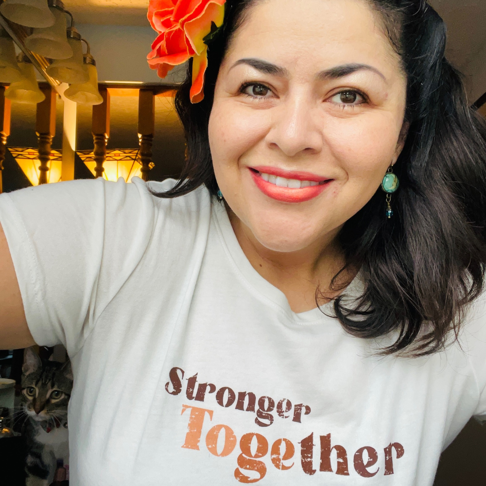 Mae Sandberg wearing a shirt that says "Stronger Together" to celebrate Hispanic Heritage Month