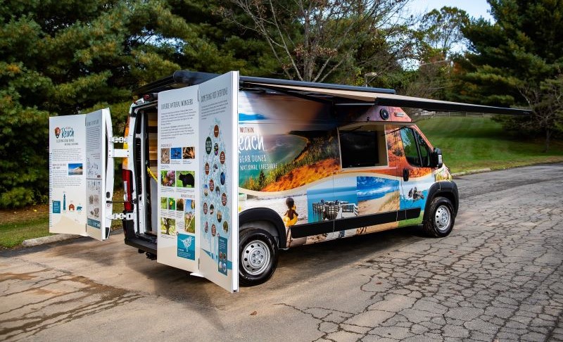 The Sleeping Bear Dunes National Lakeshore Mobile Visitor Center with fold-out exhibition panels and a retractable awning.