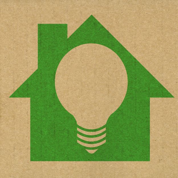 Green home icon with a lightbulb in the middle