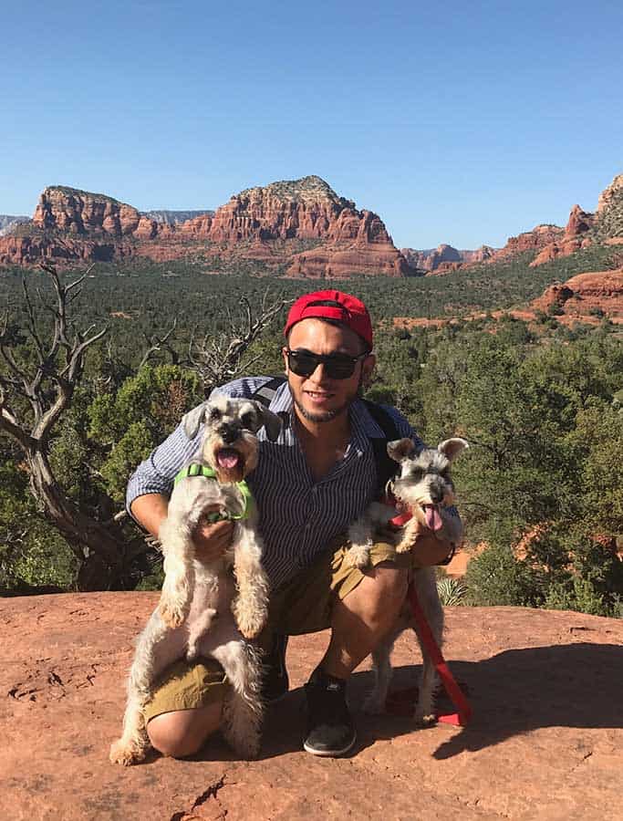 Aart poses with two dogs while on a hike