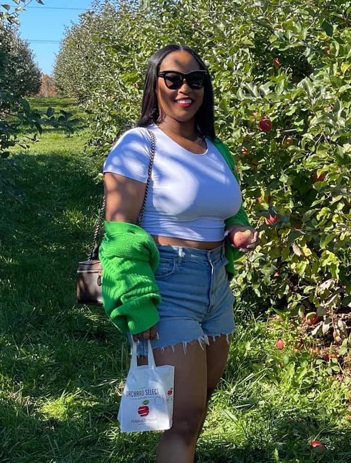 Jennifer smiles at an orchard