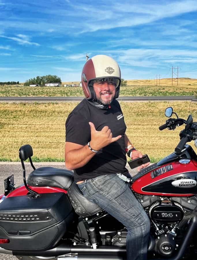Josh smiles on his Harley-Davidson bike